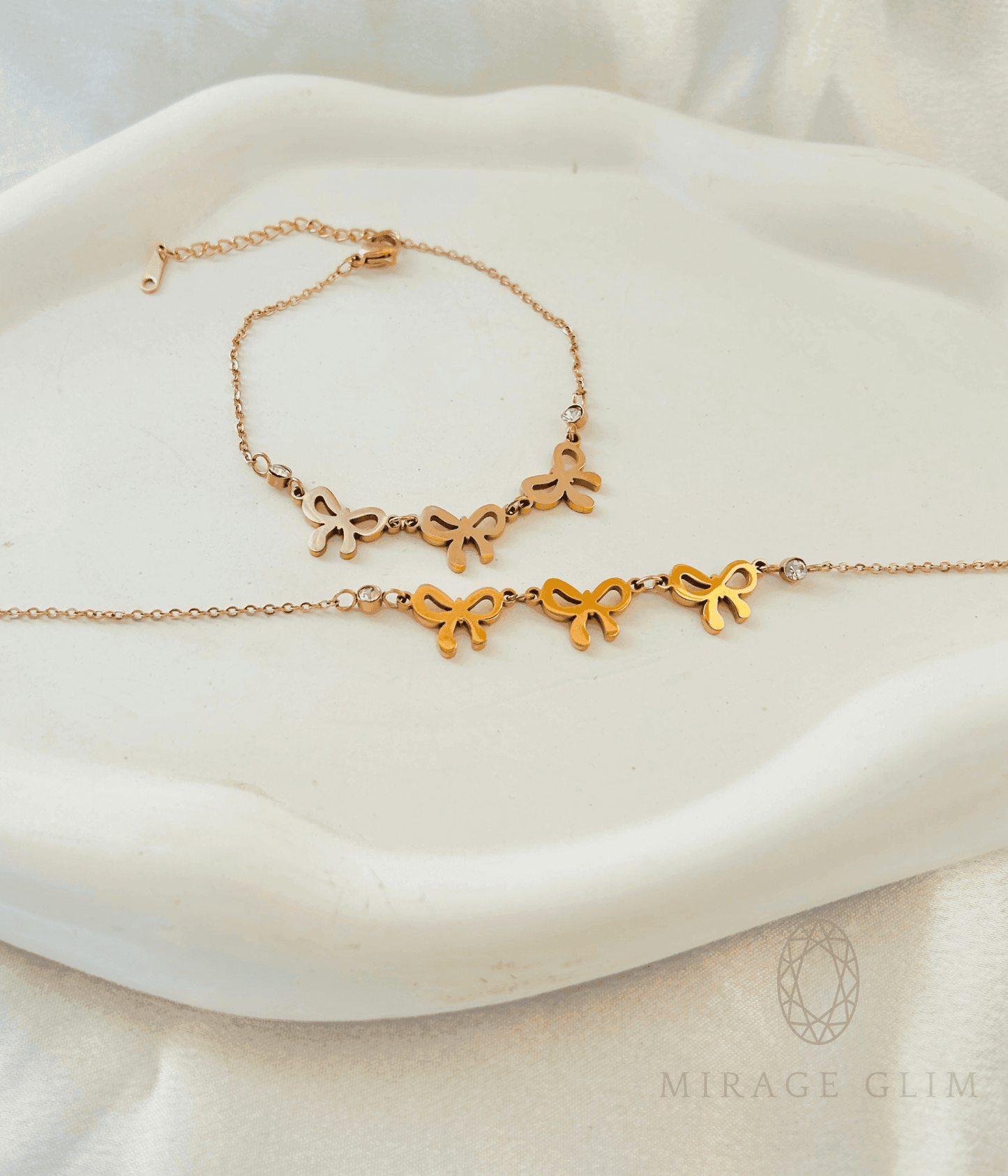 Minimal bow bracelet with small bow-shaped details displayed on a neutral background