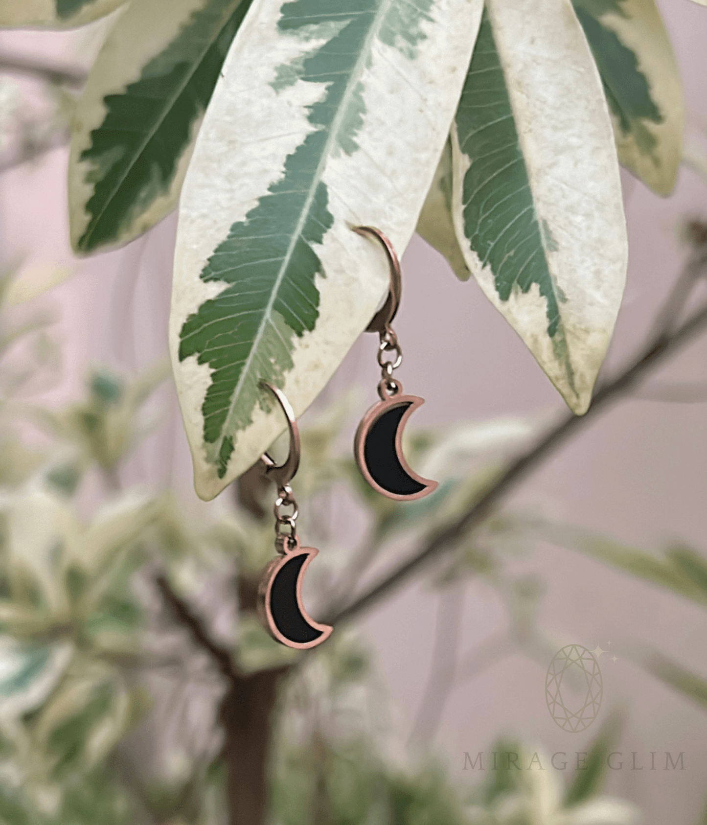 Crescent shaped moon earrings hanging delicately