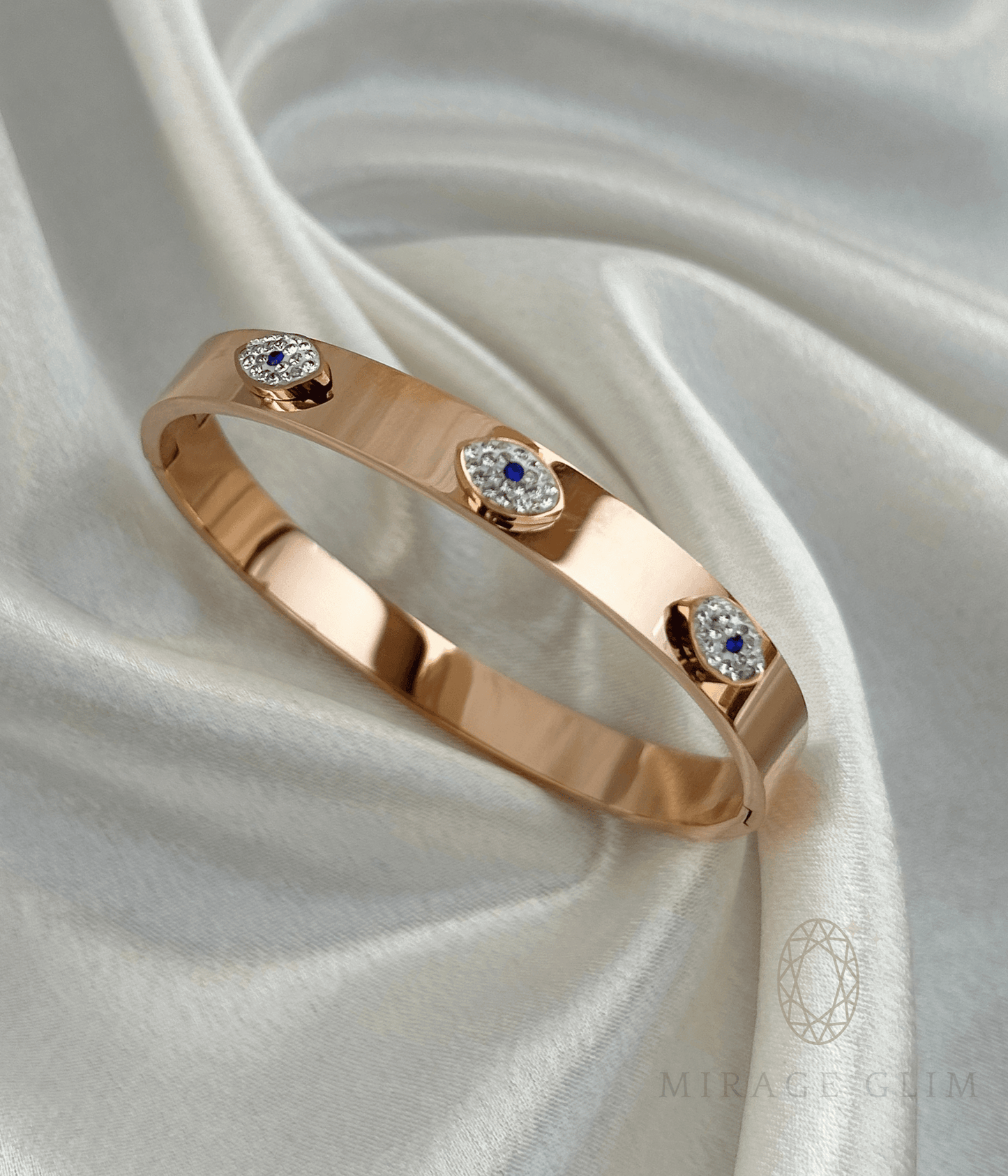 evil eye cuff bracelet with blue and crystal accents on satin fabric