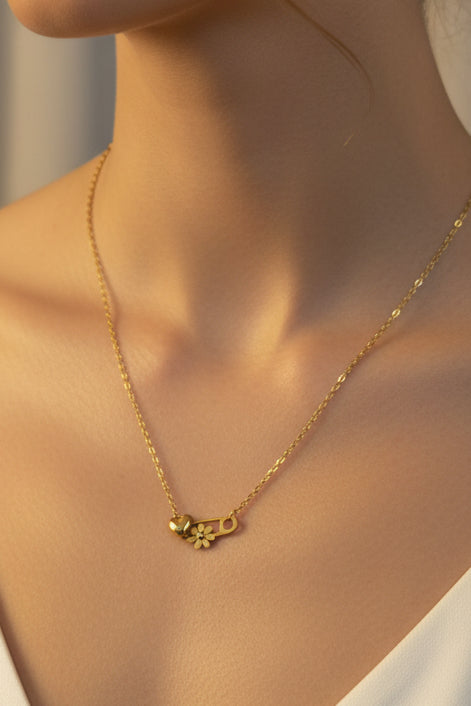 Minimalist gold anti-tarnish necklace featuring a lock-inspired pendant with delicate crystal accents on a fine gold chain.