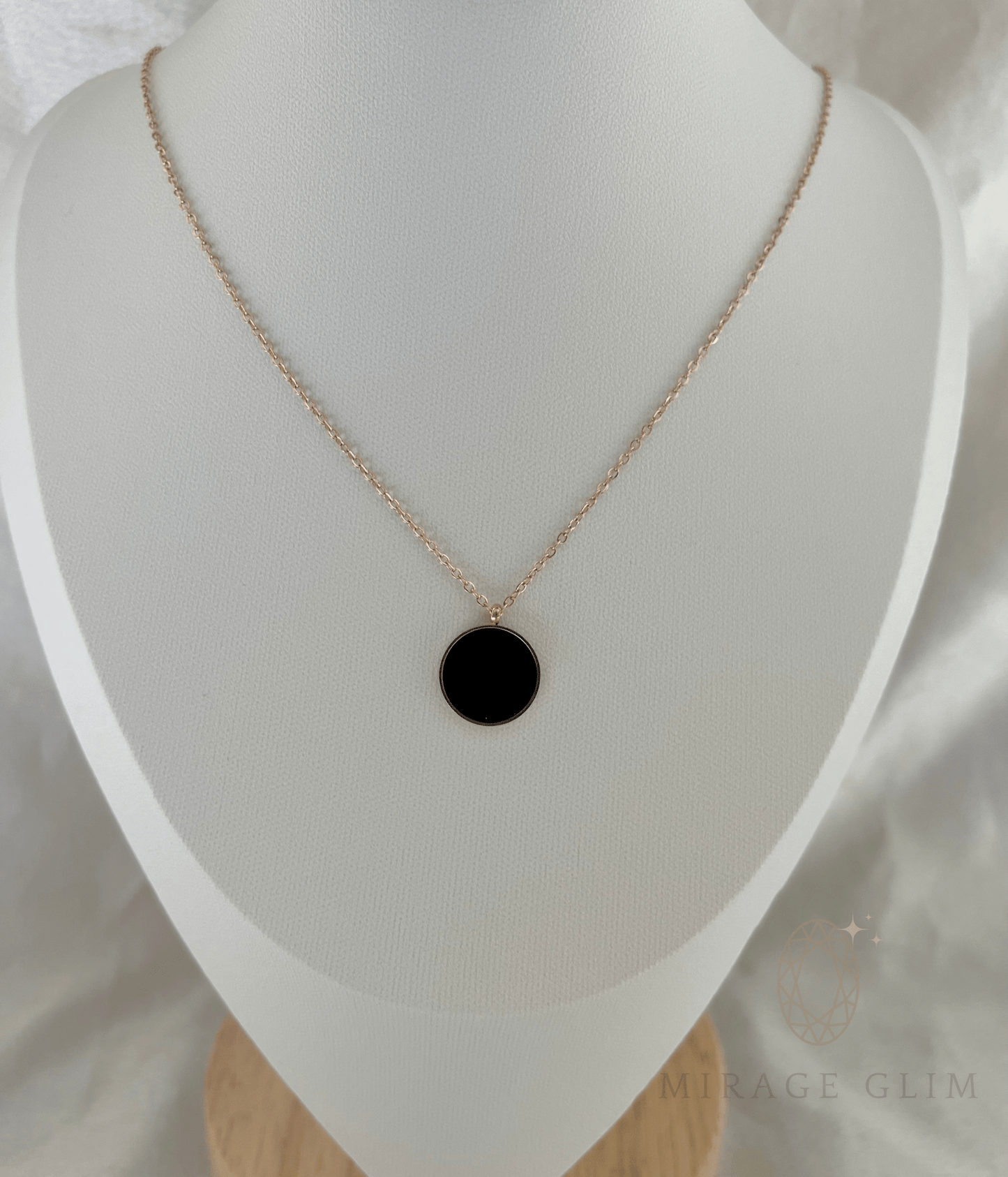 Minimalist round black pendant necklace with a sleek polished finish on a delicate rose gold chain, perfect for modern everyday and elegant styling.