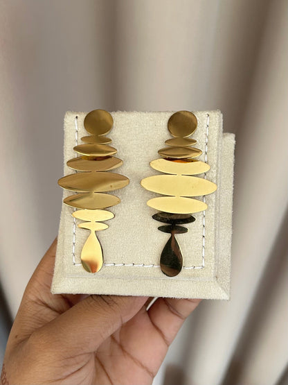 Gold stacked disc earrings on display stand