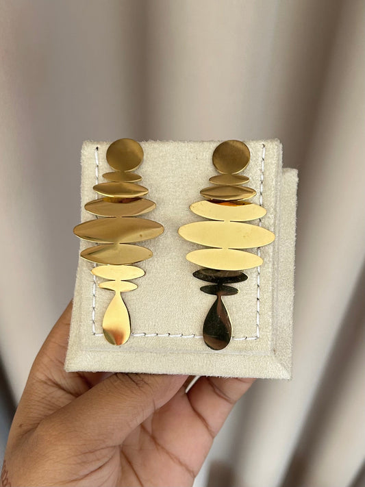 Gold stacked disc earrings on display stand