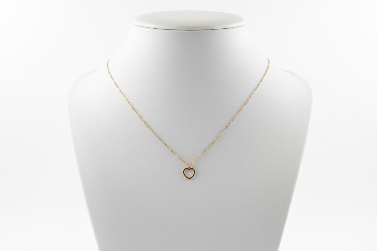 Gold necklace on a textured gray surface