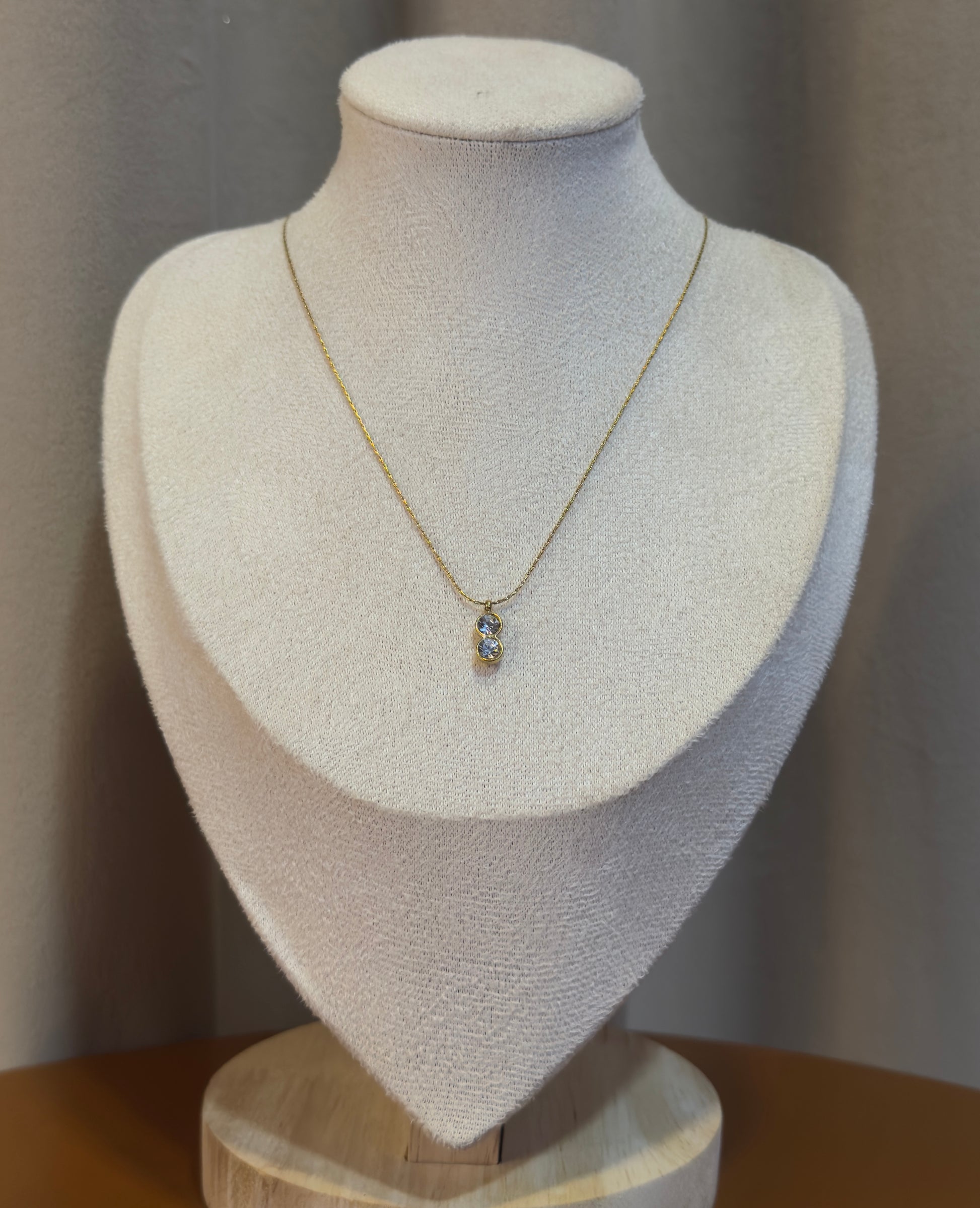 Elegant anti-tarnish gold pendant necklace featuring a sparkling crystal stone on a delicate gold chain, perfect for everyday wear and special occasions.