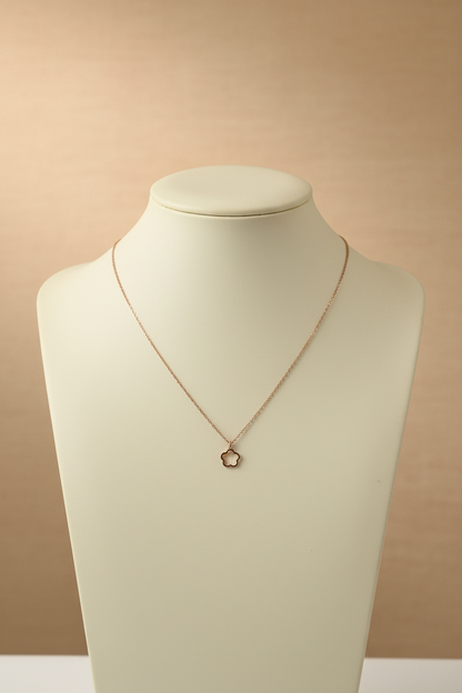Necklace with a small pendant on a textured gray surface
