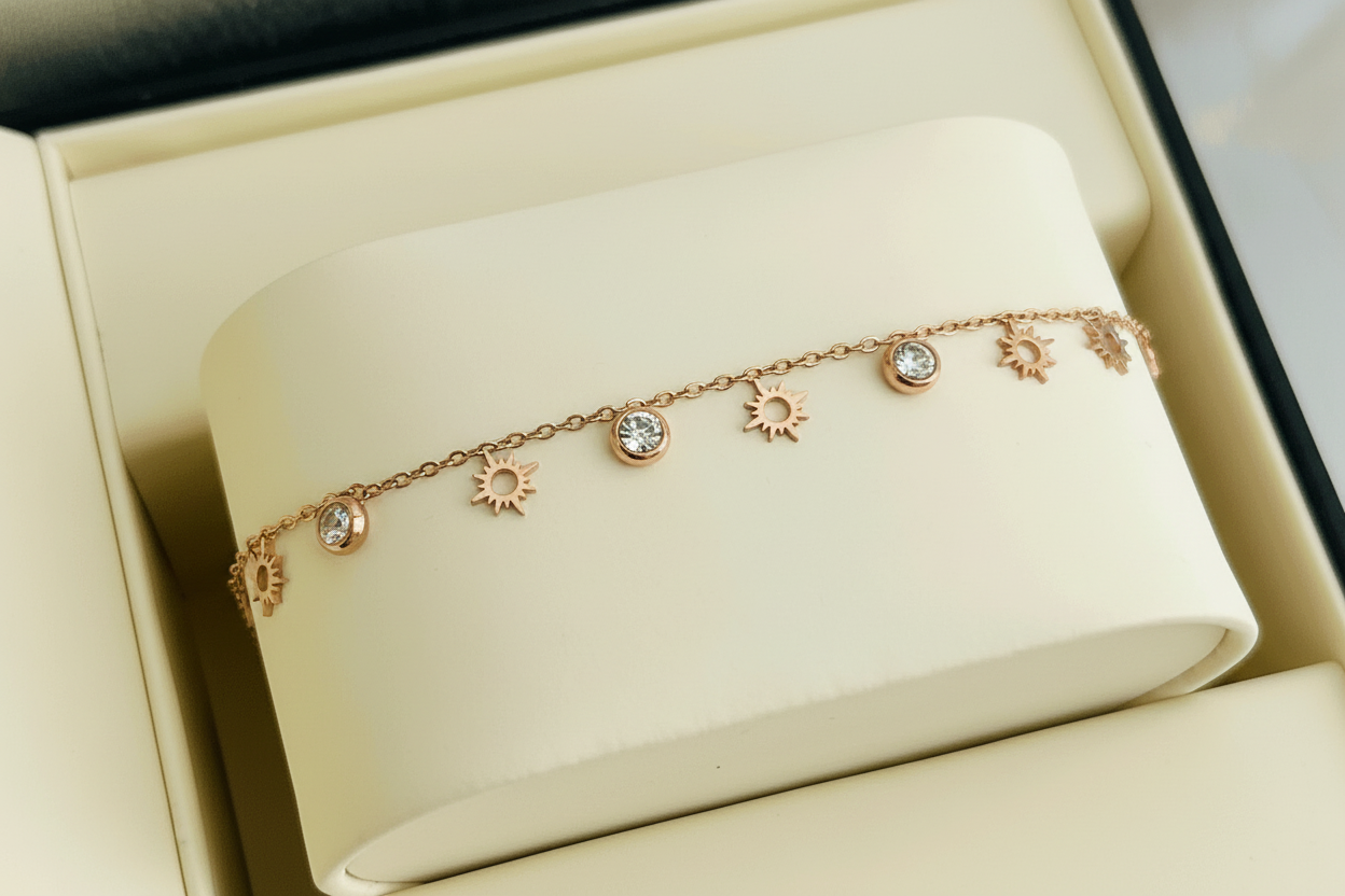 Minimal celestial-inspired bracelet with delicate charms and subtle sparkle displayed in a jewelry box
