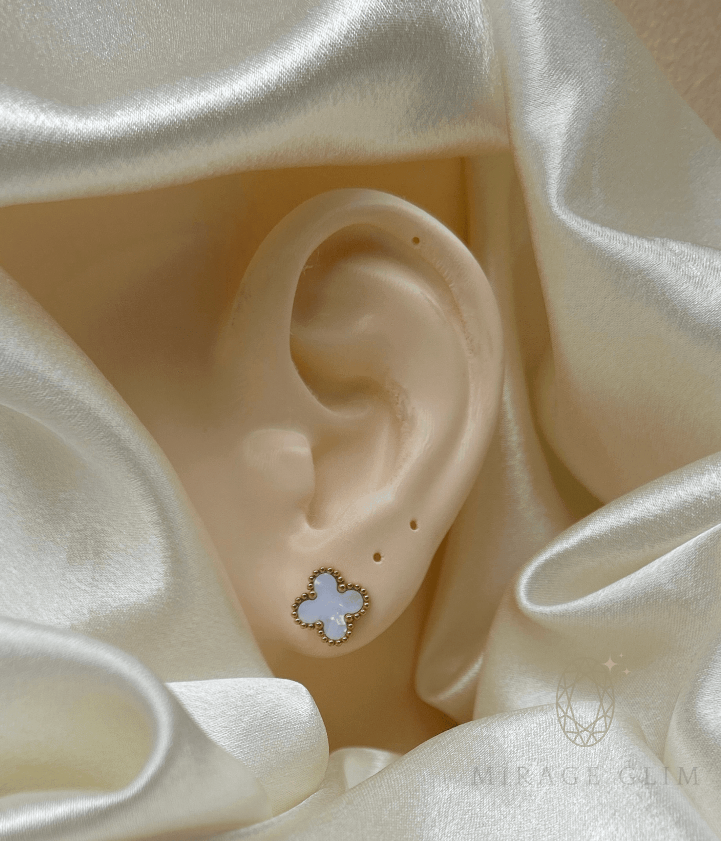 Minimal white clover inspired stud earring worn on ear