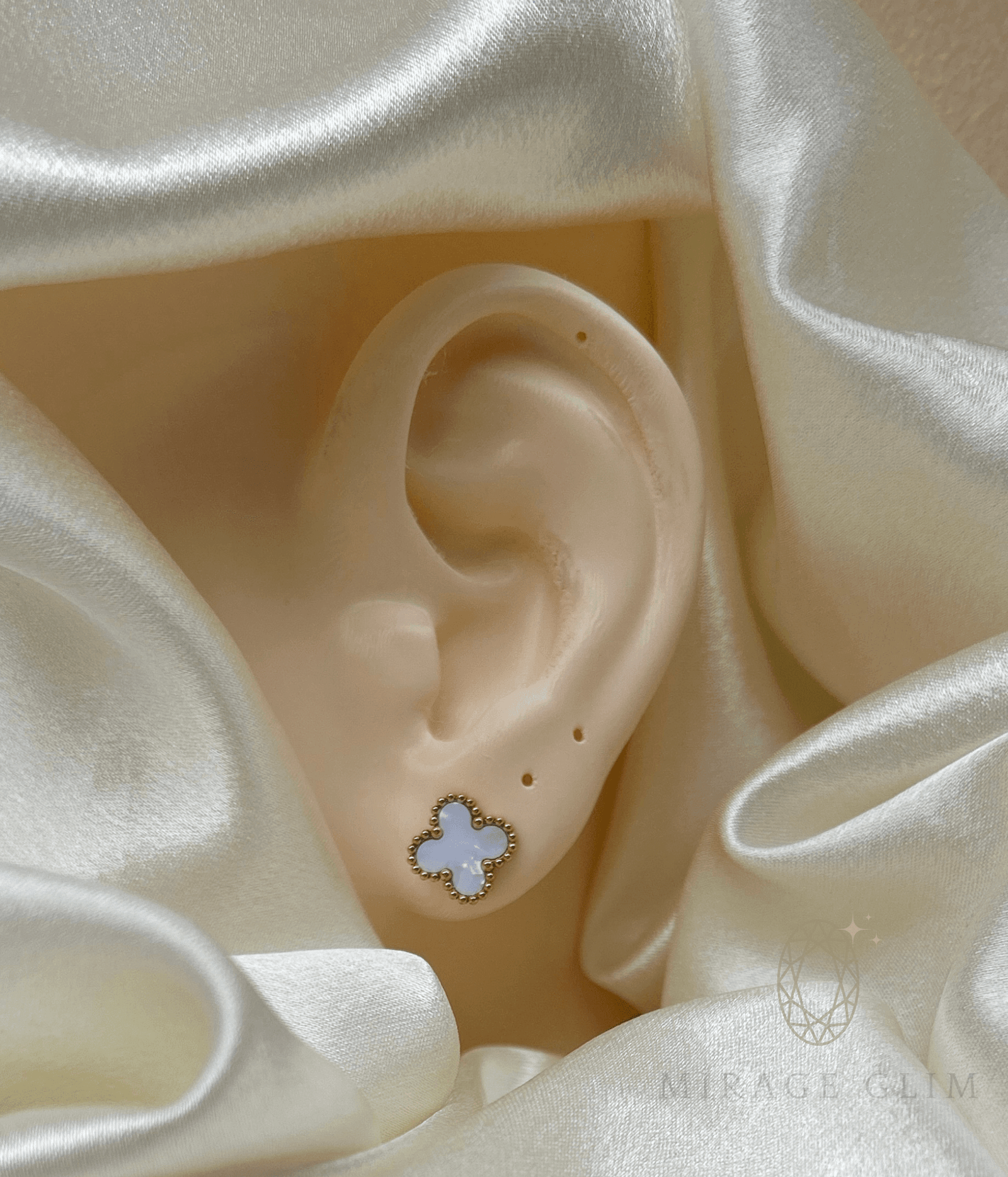 Minimal white clover inspired stud earring worn on ear