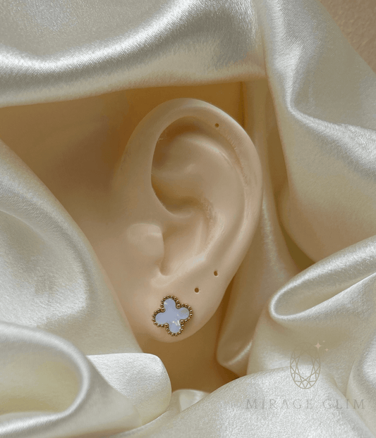 Minimal white clover inspired stud earring worn on ear