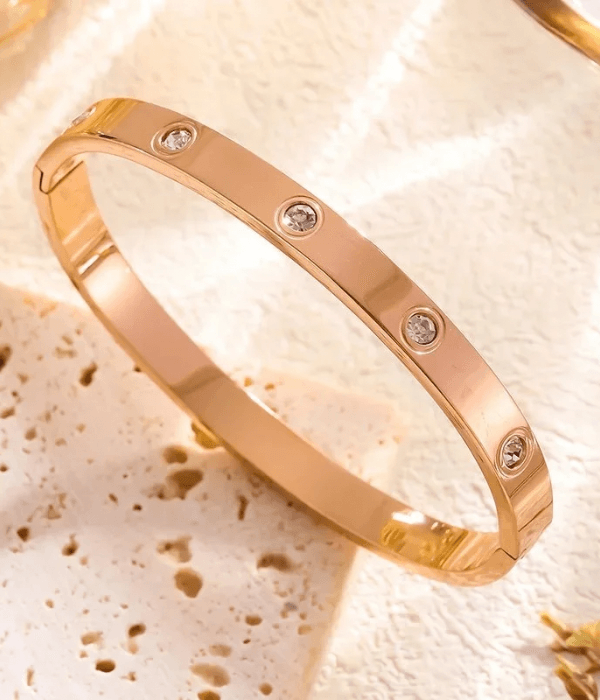 Rose gold crystal screw bangle bracelet with a polished finish, featuring a modern luxury design for elegant everyday wear