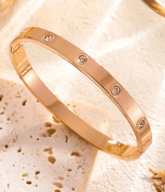 Rose gold crystal screw bangle bracelet with a polished finish, featuring a modern luxury design for elegant everyday wear