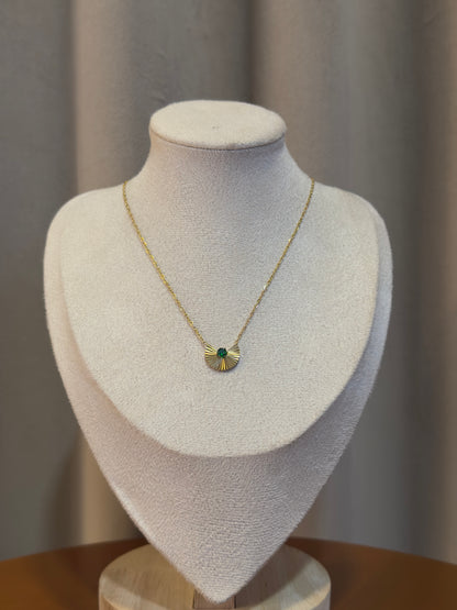 Elegant gold anti-tarnish necklace featuring a fan-shaped pendant with a sparkling emerald green crystal centerpiece on a delicate chain.
