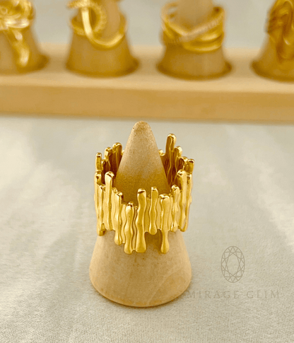 Forest Embrace gold ring with organic flowing texture displayed on a wooden ring stand