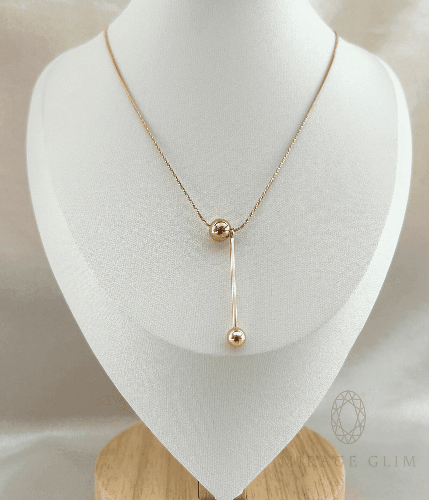 Elegant drop necklace with elongated vertical design on jewelry bust
