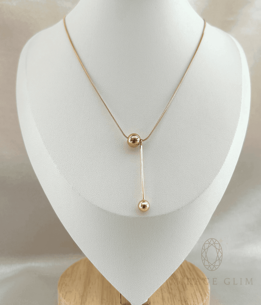 Elegant drop necklace with elongated vertical design on jewelry bust