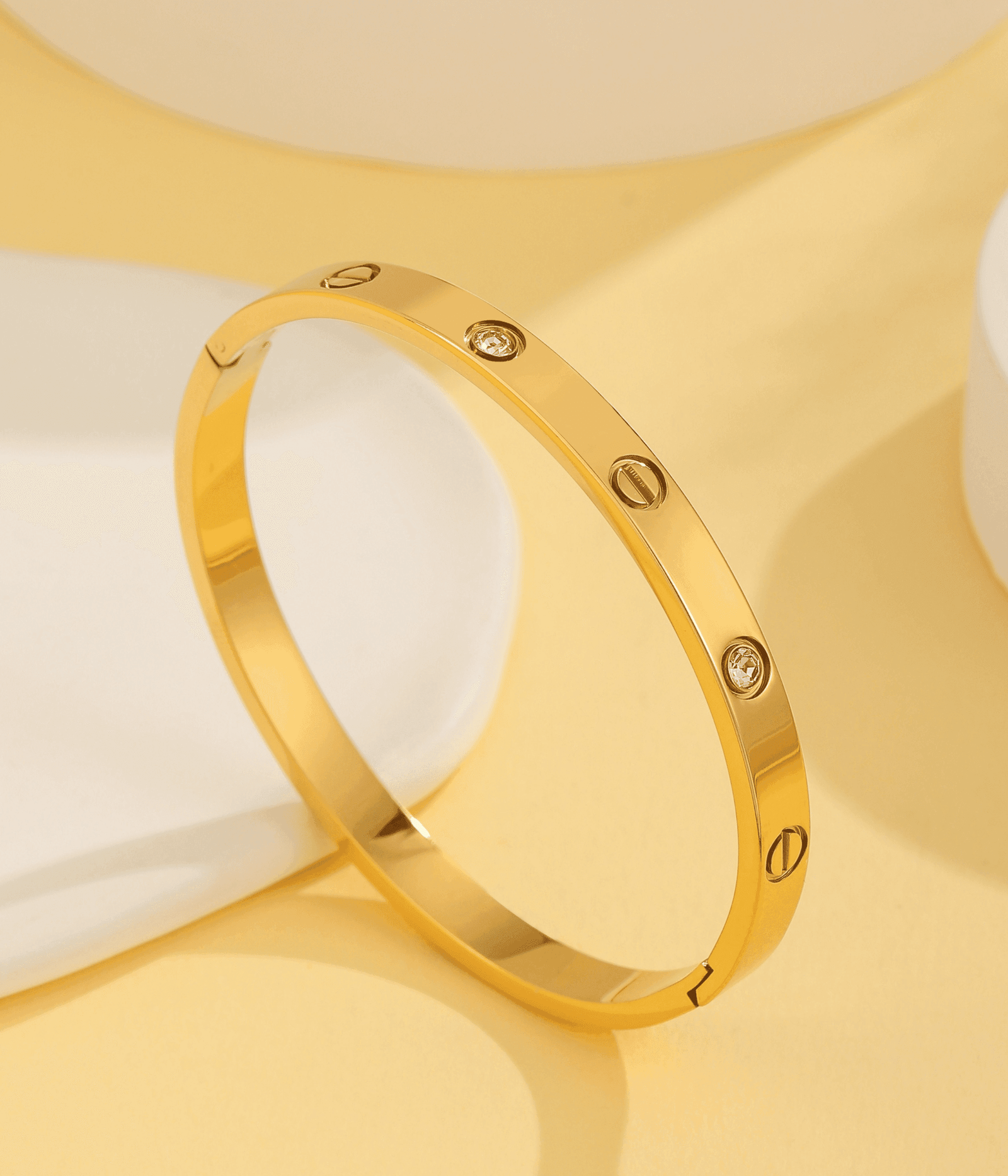 Polished gold crystal screw bangle bracelet featuring a timeless luxury design, perfect for elegant everyday and occasion wear