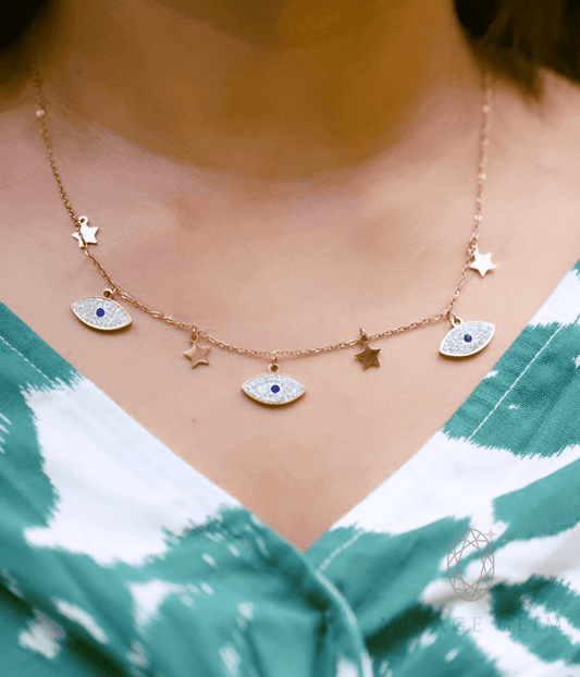 Minimal evil eye necklace with star accents styled casually