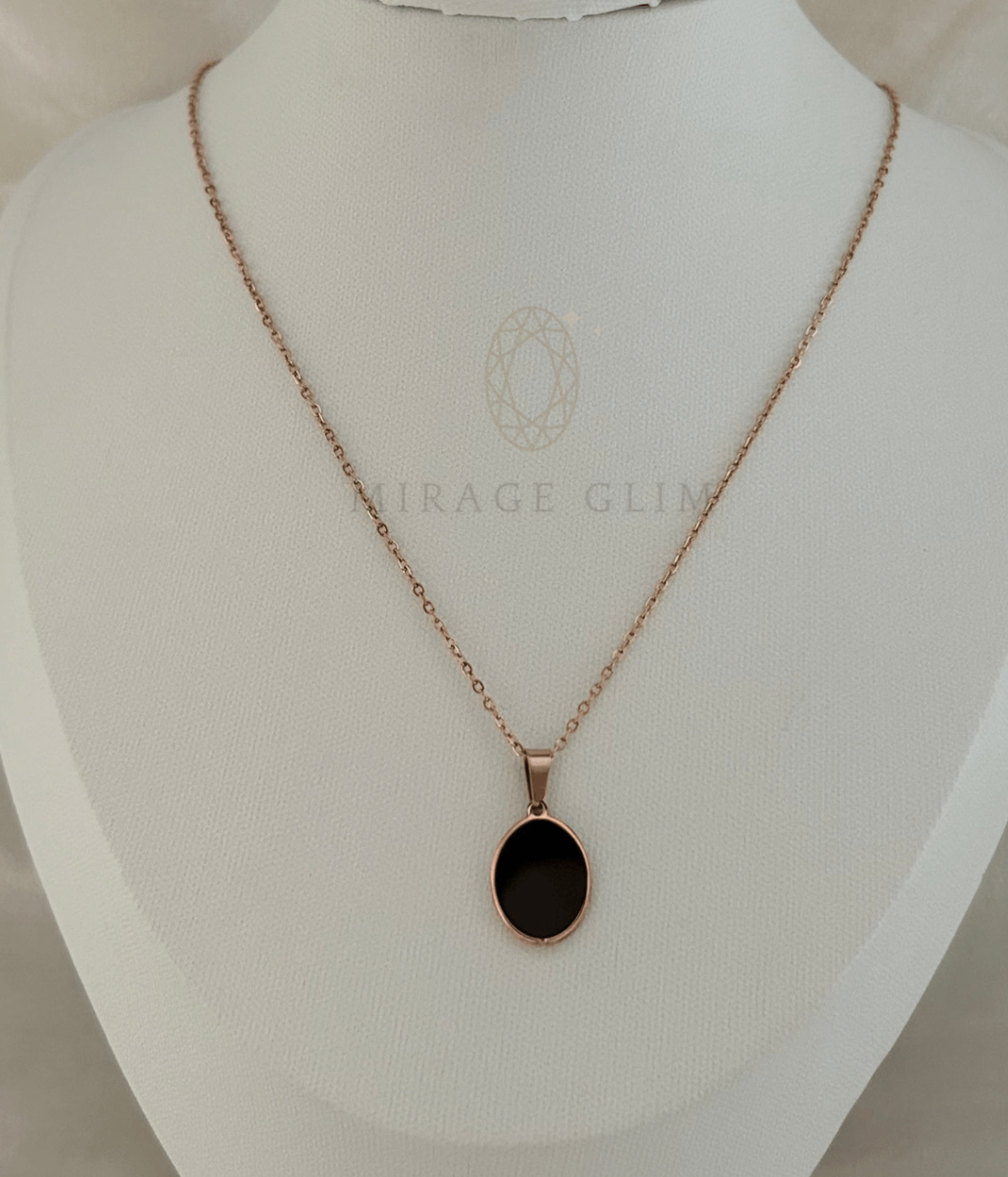 Black oval pendant necklace on rose gold tone chain