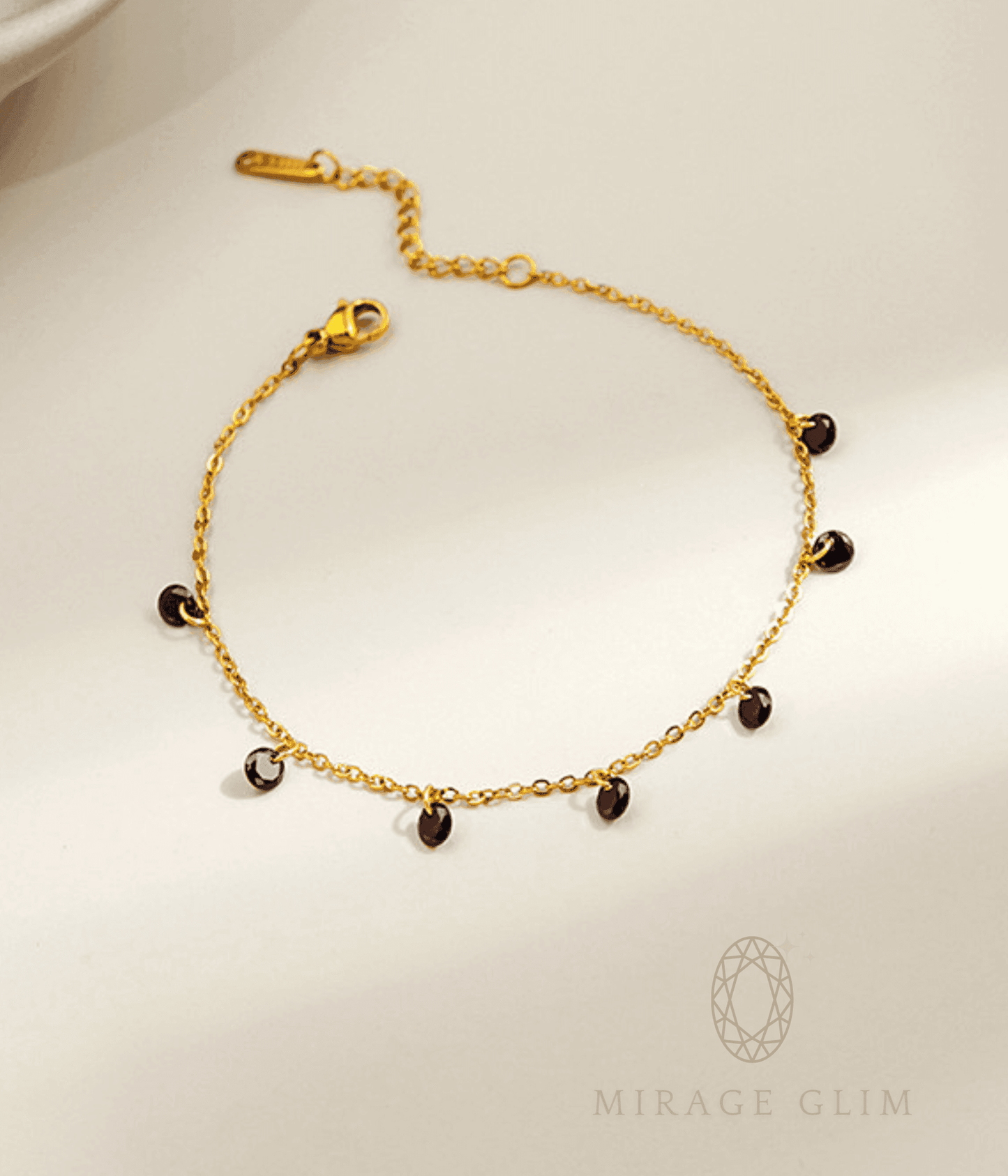 Anklet with small dark drop accents on a fine chain