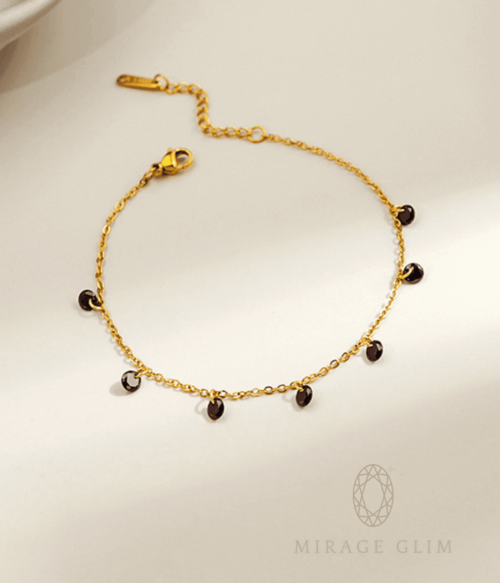 Anklet with small dark drop accents on a fine chain
