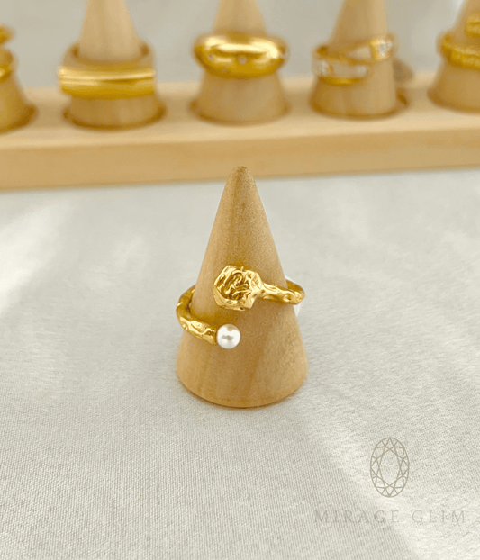 Gold swirl ring with delicate pearl accent in minimal design