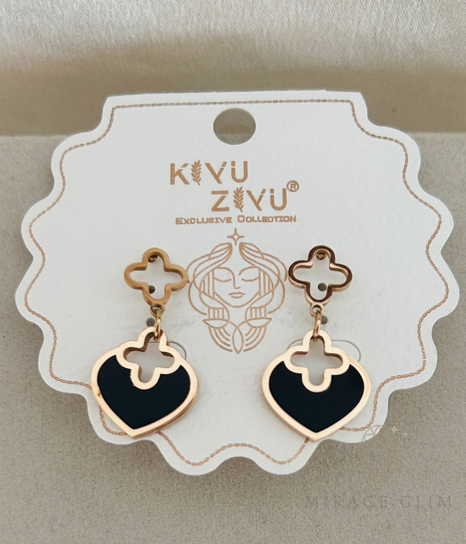 Black heart earrings with gold clover accents in refined style