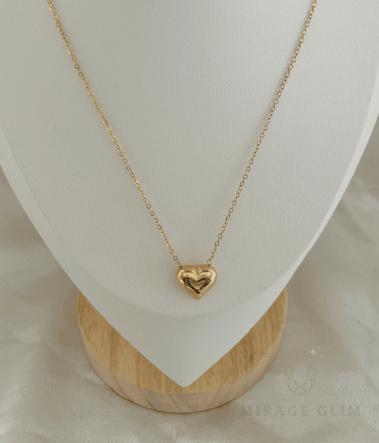 heart pendant necklace displayed on a minimal white jewelry stand