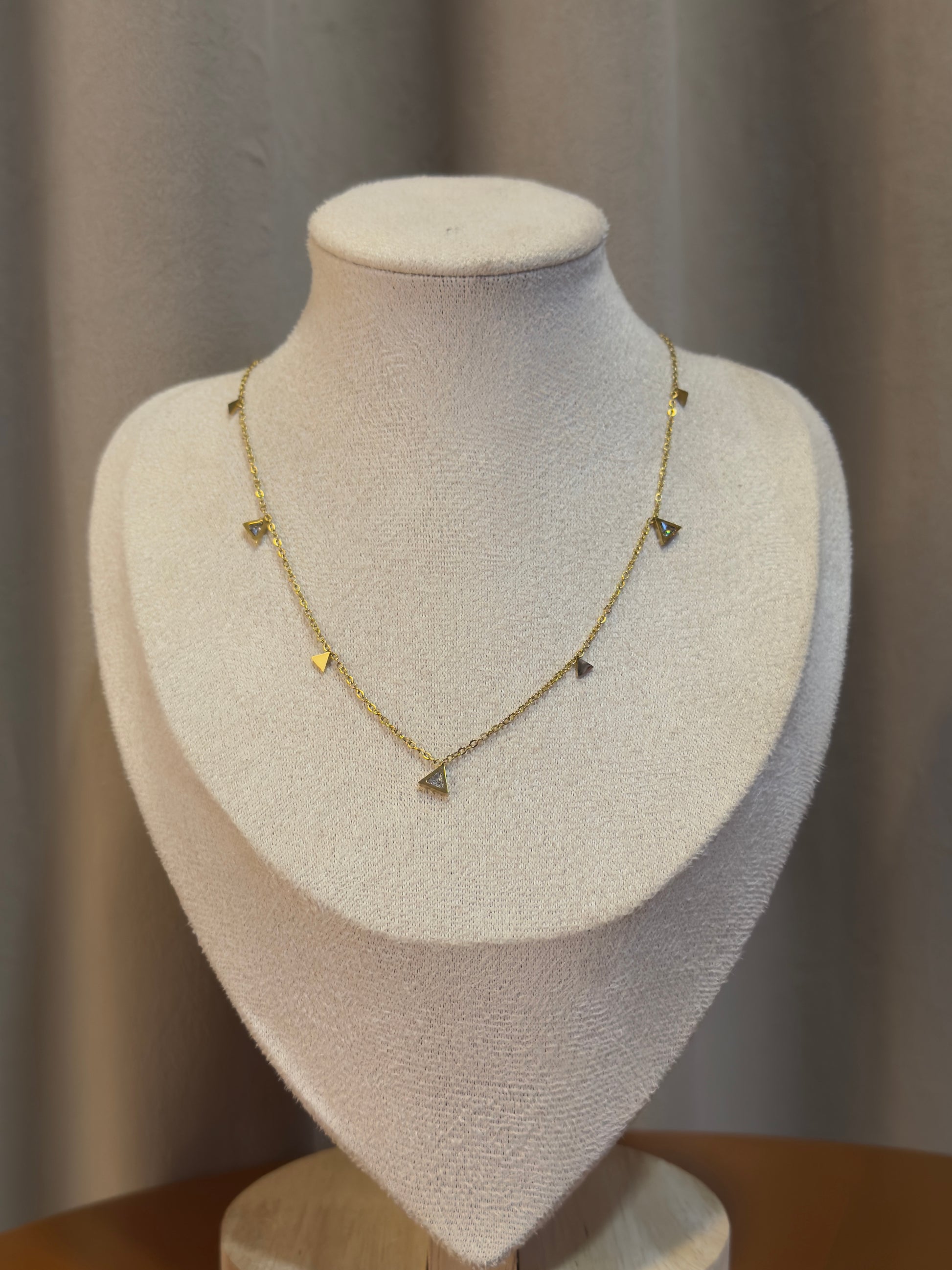 Necklace on a mannequin bust with a neutral background