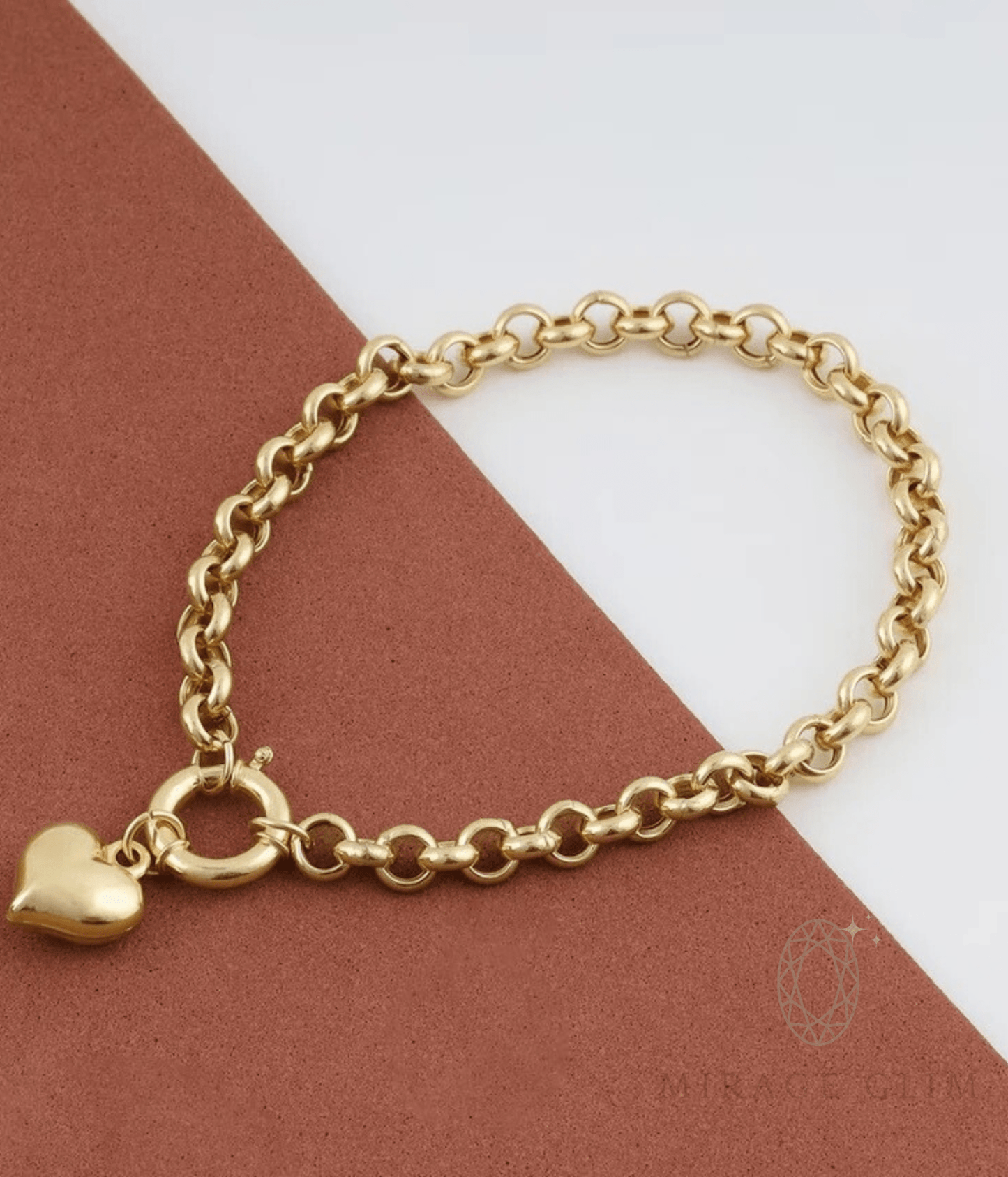 Gold chain bracelet with a heart charm on a brown and white background
